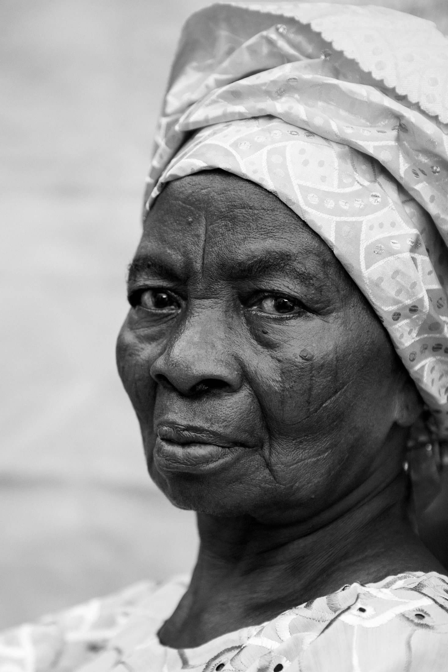 Elder portrait, scarification and eyelet lace carved by raking light
