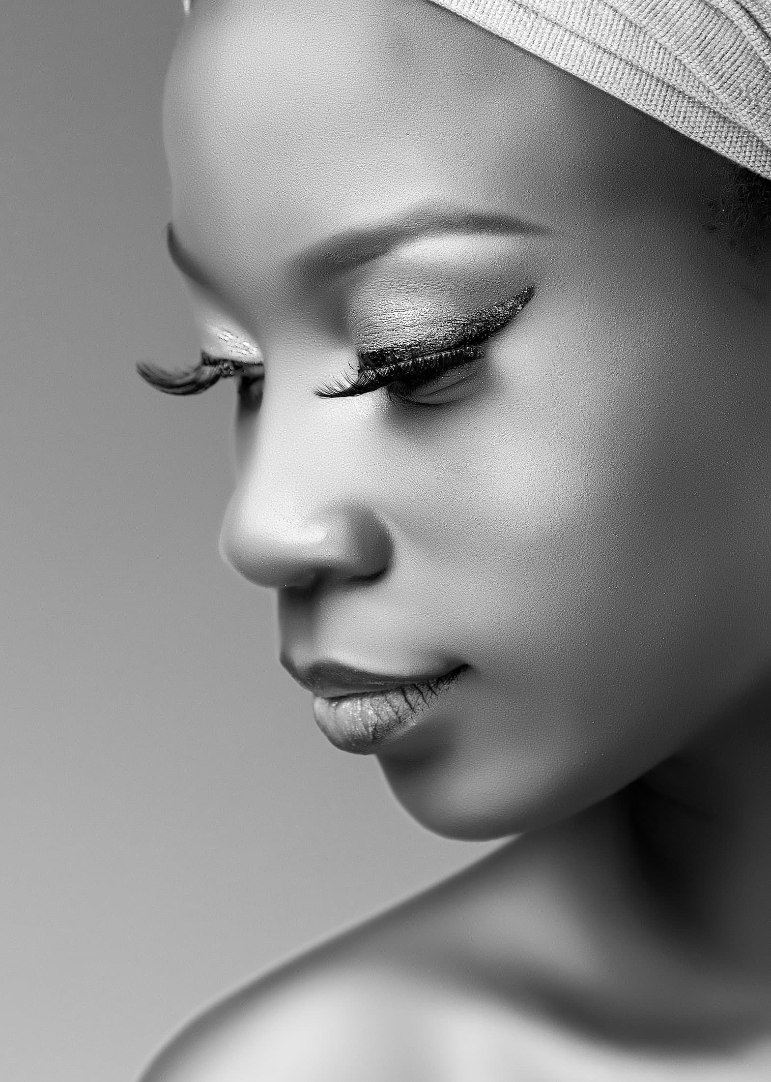 Editorial beauty portrait, winged liner against luminous skin, black and white